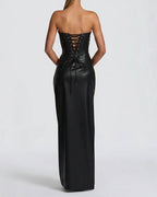 Black strapless gown with lace-up back on a white background