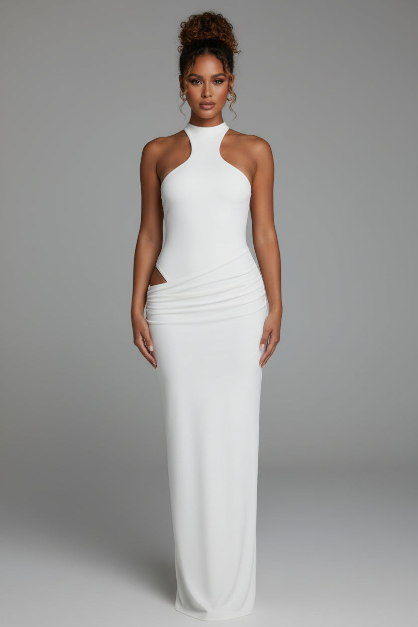 Woman in a white dress standing in a modern living room.