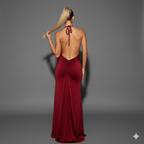 Woman wearing a burgundy evening gown with a halter neck design on a gray background